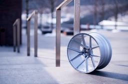 JR Wheels JR30 Silver alloy wheel mounted on car in an atmospheric setting
