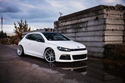 JR Wheels JR30 Silver alloy wheel mounted on car in an atmospheric setting