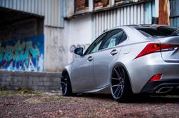 JR Wheels JR30 Grey alloy wheel mounted on car in an atmospheric setting