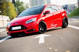 JR Wheels JR3 Black alloy wheel mounted on car in an atmospheric setting