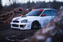 JR Wheels JR3 Black alloy wheel mounted on car in an atmospheric setting