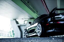 JR Wheels JR32 White alloy wheel mounted on car in an atmospheric setting