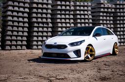 JR Wheels JR32 Gold alloy wheel mounted on car in an atmospheric setting