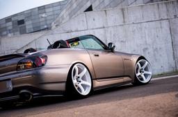 JR Wheels JR32 White alloy wheel mounted on car in an atmospheric setting