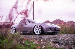 JR Wheels JR32 White alloy wheel mounted on car in an atmospheric setting