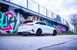 JR Wheels JR33 Black alloy wheel mounted on car in an atmospheric setting