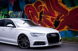 JR Wheels JR33 Grey alloy wheel mounted on car in an atmospheric setting