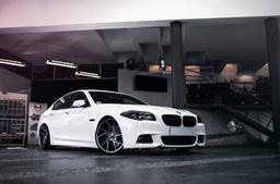 JR Wheels JR33 Grey alloy wheel mounted on car in an atmospheric setting