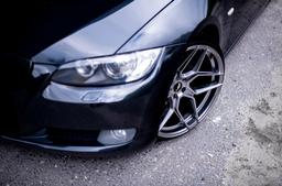 JR Wheels JR34 Grey alloy wheel mounted on car in an atmospheric setting