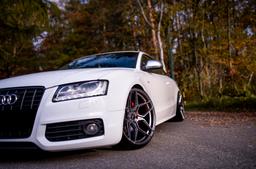 JR Wheels JR34 Grey alloy wheel mounted on car in an atmospheric setting