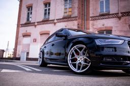 JR Wheels JR34 Silver alloy wheel mounted on car in an atmospheric setting