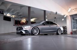 JR Wheels JR34 Silver alloy wheel mounted on car in an atmospheric setting
