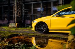 JR Wheels JR34 Black alloy wheel mounted on car in an atmospheric setting