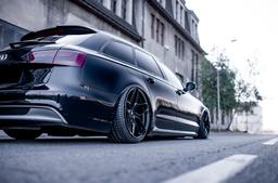 JR Wheels JR34 Black alloy wheel mounted on car in an atmospheric setting