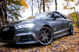 JR Wheels JR34 Grey alloy wheel mounted on car in an atmospheric setting