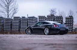 JR Wheels JR34 Silver alloy wheel mounted on car in an atmospheric setting