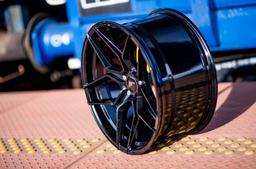 JR Wheels JR35 Black alloy wheel mounted on car in an atmospheric setting