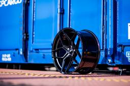 JR Wheels JR35 Black alloy wheel mounted on car in an atmospheric setting