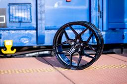 JR Wheels JR35 Black alloy wheel mounted on car in an atmospheric setting