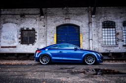 JR Wheels JR36 Grey alloy wheel mounted on car in an atmospheric setting