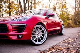 JR Wheels JR36 Silver alloy wheel mounted on car in an atmospheric setting