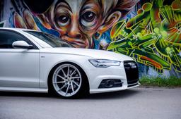 JR Wheels JR36 Silver alloy wheel mounted on car in an atmospheric setting