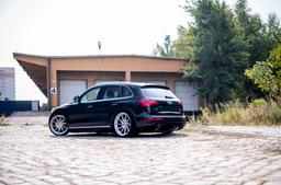 JR Wheels JR36 Silver alloy wheel mounted on car in an atmospheric setting