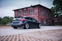 JR Wheels JR36 Silver alloy wheel mounted on car in an atmospheric setting