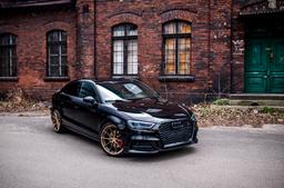 JR Wheels JR37 Bronze alloy wheel mounted on car in an atmospheric setting