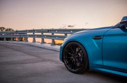 JR Wheels JR37 Black alloy wheel mounted on car in an atmospheric setting