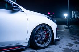 JR Wheels JR37 Grey alloy wheel mounted on car in an atmospheric setting