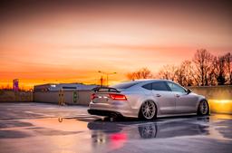 JR Wheels JR37 Silver alloy wheel mounted on car in an atmospheric setting