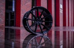 JR Wheels JR37 Black alloy wheel mounted on car in an atmospheric setting