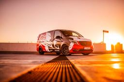 JR Wheels JR38 Black alloy wheel mounted on car in an atmospheric setting