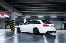 JR Wheels JR38 Black alloy wheel mounted on car in an atmospheric setting