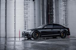 JR Wheels JR38 Black alloy wheel mounted on car in an atmospheric setting