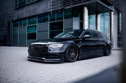 JR Wheels JR38 Black alloy wheel mounted on car in an atmospheric setting