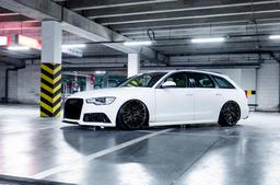JR Wheels JR38 Black alloy wheel mounted on car in an atmospheric setting