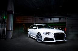 JR Wheels JR38 Silver alloy wheel mounted on car in an atmospheric setting