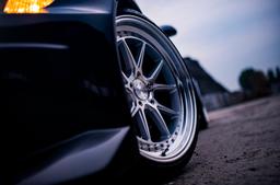 JR Wheels JR39 Silver alloy wheel mounted on car in an atmospheric setting