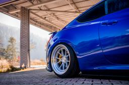 JR Wheels JR39 Silver alloy wheel mounted on car in an atmospheric setting