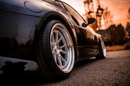 JR Wheels JR39 Silver alloy wheel mounted on car in an atmospheric setting