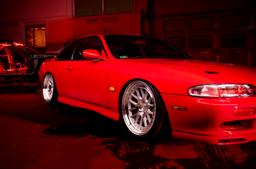 JR Wheels JR40 Silver alloy wheel mounted on car in an atmospheric setting