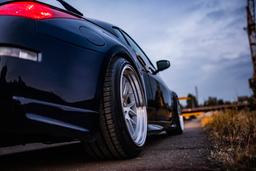 JR Wheels JR40 Silver alloy wheel mounted on car in an atmospheric setting