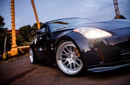 JR Wheels JR40 Silver alloy wheel mounted on car in an atmospheric setting
