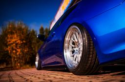 JR Wheels JR40 Silver alloy wheel mounted on car in an atmospheric setting