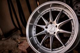 JR Wheels JR41 Silver alloy wheel mounted on car in an atmospheric setting