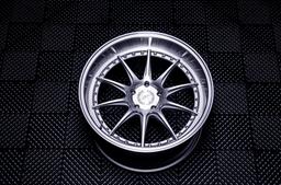 JR Wheels JR41 Silver alloy wheel mounted on car in an atmospheric setting
