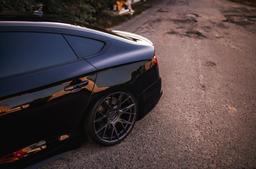 JR Wheels JR42 Grey alloy wheel mounted on car in an atmospheric setting