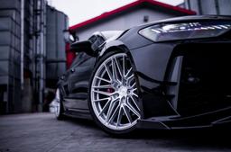 JR Wheels JR42 Silver alloy wheel mounted on car in an atmospheric setting